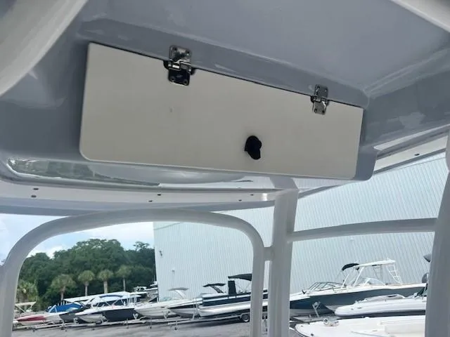 Slide: The Image of 2022 Robalo R222 Center Console boat interior with storage compartment. - 22