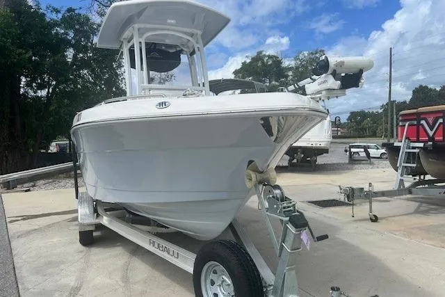 Slide: The Image of 2022 Robalo R222 Center Console boat on trailer, parked outdoors. - 3