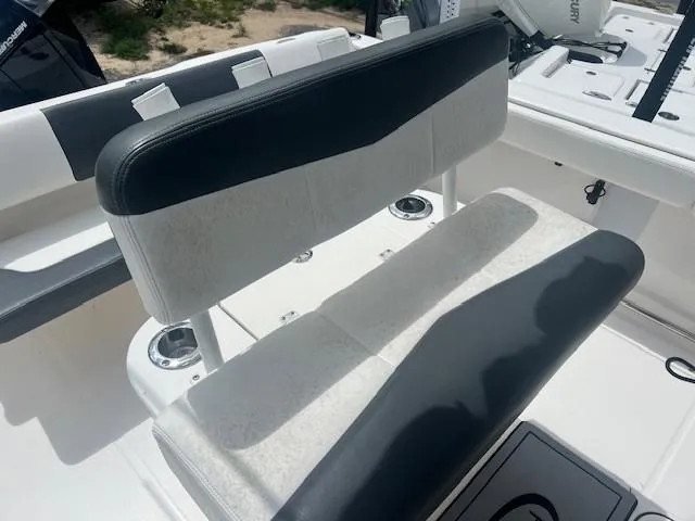 Slide: The Image of 2022 Robalo R222 Center Console boat seating with black and white upholstery. - 8