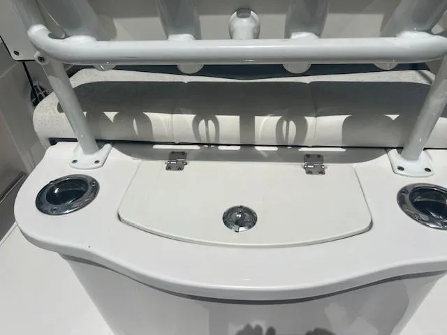 Slide: The Image of 2022 Robalo R222 Center Console boat seating and storage area with cup holders. - 9