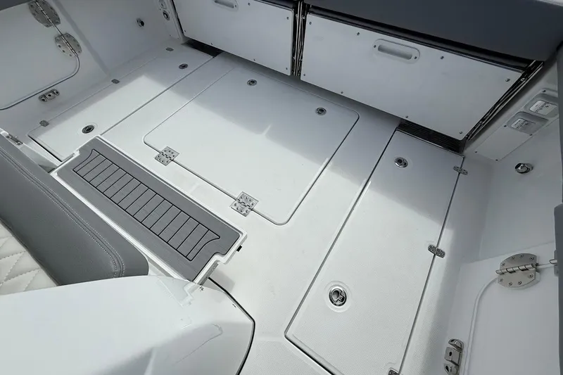 Slide: The Image of 2026 Everglades 375 Center Console boat deck with storage compartments and seating. - 12