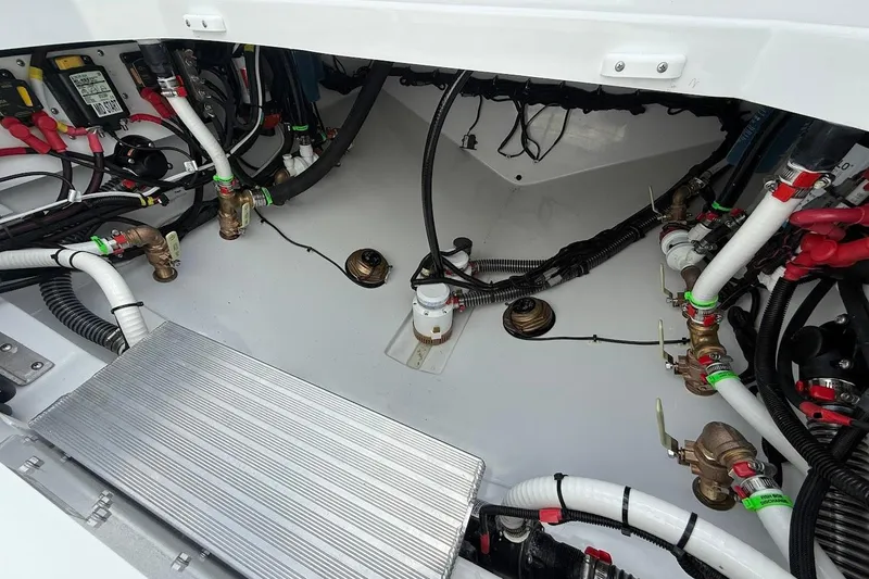 Slide: The Image of Engine compartment of 2026 Everglades 375 Center Console with wiring and plumbing details. - 14