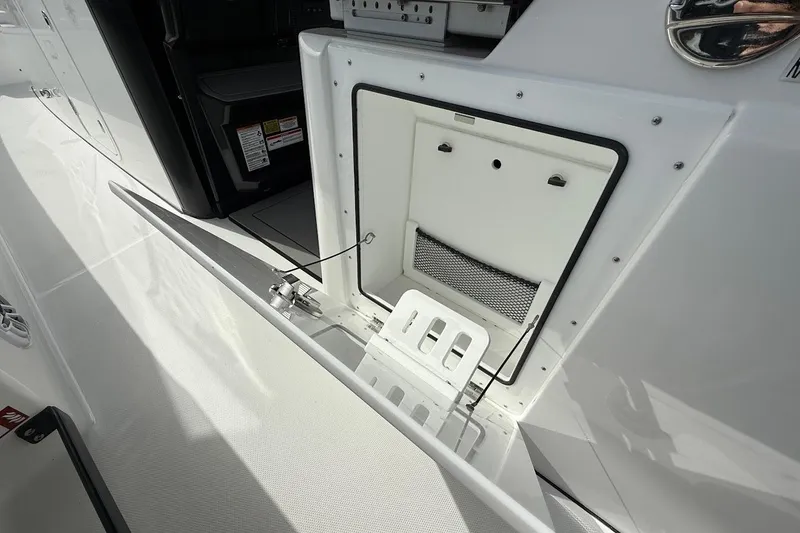 Slide: The Image of 2026 Everglades 375 Center Console boat, open storage compartment detail. - 18