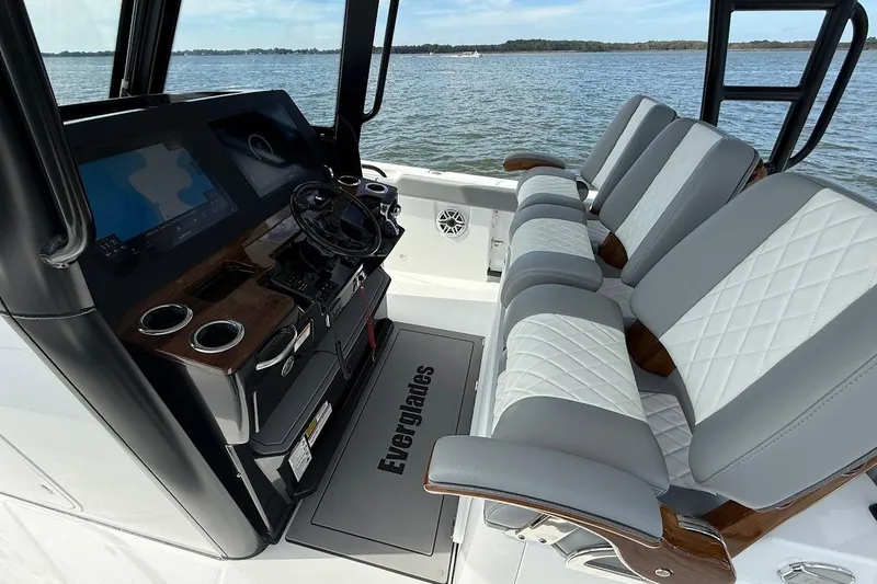 Slide: The Image of 2026 Everglades 375 Center Console boat interior with modern helm and seating. - 19
