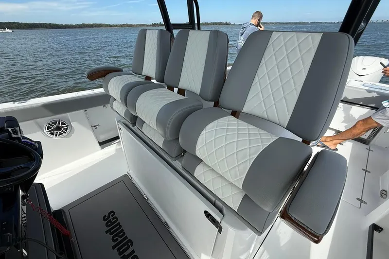 Slide: The Image of 2026 Everglades 375 Center Console boat with luxurious seating on a calm water backdrop. - 20