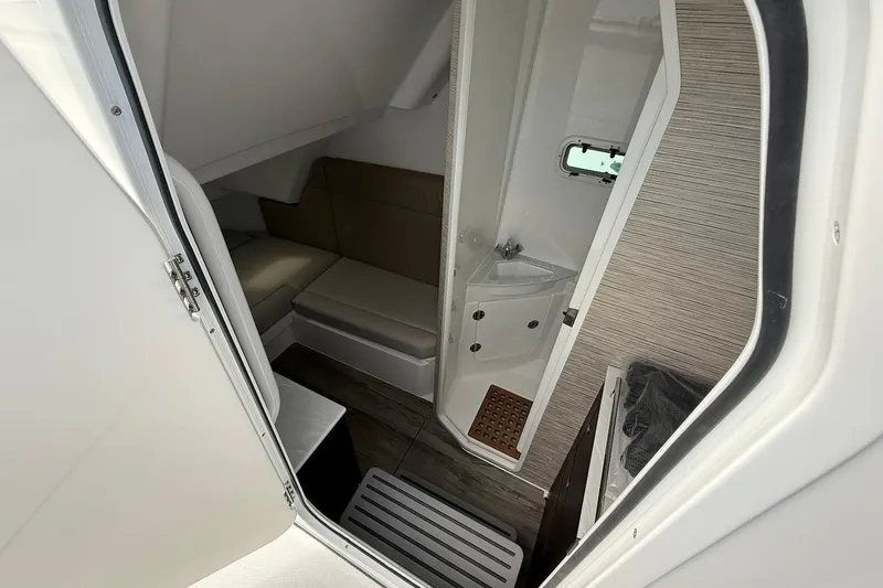 Slide: The Image of Interior cabin of 2026 Everglades 375 Center Console with seating and compact sink. - 25