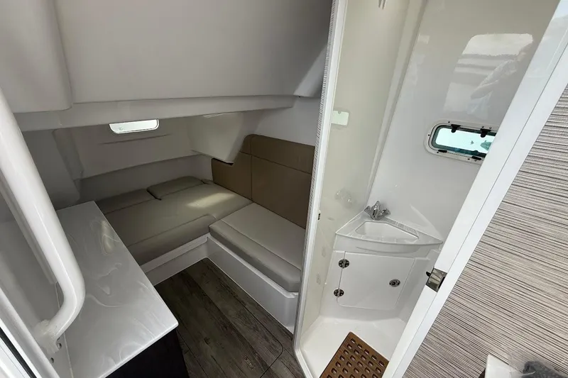 Slide: The Image of Interior cabin of 2026 Everglades 375 Center Console with seating and compact sink. - 26