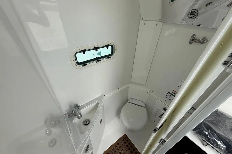 Slide: The Image of Interior of 2026 Everglades 375 Center Console boat bathroom with sink and toilet. - 27