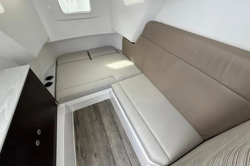 Slide: The Image of Interior cabin of 2026 Everglades 375 Center Console with beige seating and wood flooring. - 28