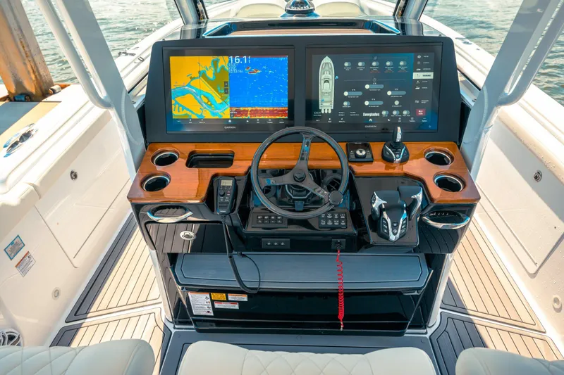 Slide: The Image of 2026 Everglades 375 Center Console boat with triple Yamaha engines on open water. - 3