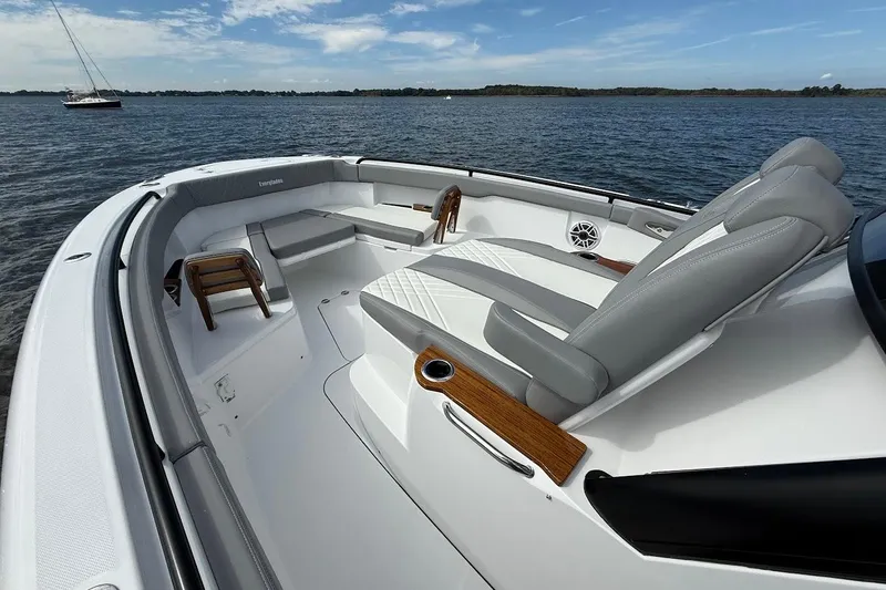Slide: The Image of 2026 Everglades 375 Center Console boat interior with luxurious seating on calm water. - 31