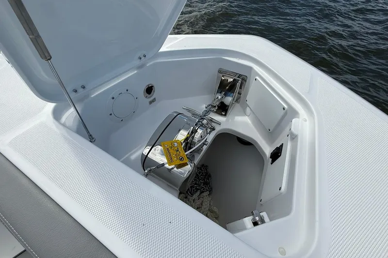 Slide: The Image of Anchor compartment of 2026 Everglades 375 Center Console boat, open lid, ocean background. - 36