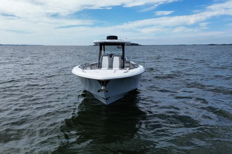 Slide: The Image of 2026 Everglades 375 Center Console boat on open water under blue sky. - 5