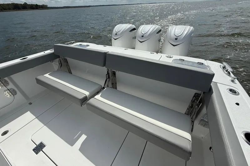 Slide: The Image of 2026 Everglades 375 Center Console boat with triple engines and foldable seating on open water. - 8