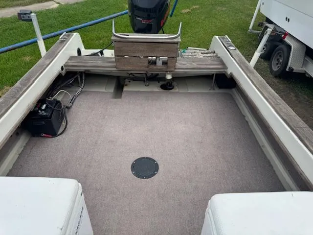 Slide: The Image of 1978 Boston Whaler 21 Outrage boat interior with carpeted deck and motor. - 10