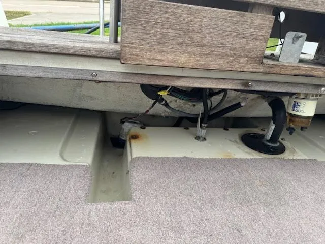 Slide: The Image of 1978 Boston Whaler 21 Outrage interior showing wiring and components under deck. - 11