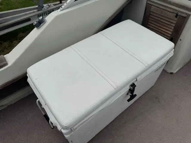 Slide: The Image of White cushioned storage bench on 1978 Boston Whaler 21 Outrage boat deck. - 12