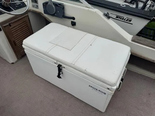 Slide: The Image of 1978 Boston Whaler 21 Outrage boat interior with white cooler and steering console. - 13