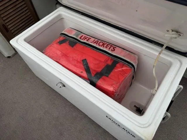 Slide: The Image of Open storage compartment on 1978 Boston Whaler 21 Outrage with life jackets inside. - 14