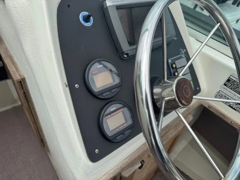 Slide: The Image of 1978 Boston Whaler 21 Outrage dashboard with steering wheel and Yamaha gauges. - 17