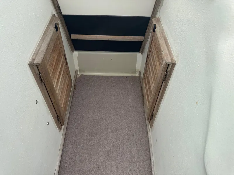 Slide: The Image of Interior view of a 1978 Boston Whaler 21 Outrage boat with wooden storage compartments. - 21