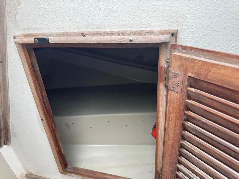 Slide: The Image of Open wooden hatch on 1978 Boston Whaler 21 Outrage boat interior. - 22