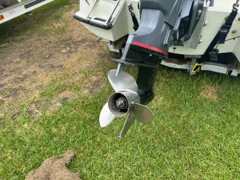 Slide: The Image of Outboard motor propeller of a 1978 Boston Whaler 21 Outrage on grass. - 3