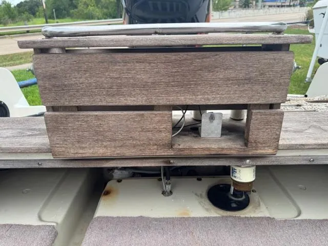 Slide: The Image of 1978 Boston Whaler 21 Outrage boat with wooden storage compartment and visible engine components. - 7