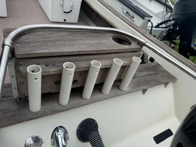 Slide: The Image of 1978 Boston Whaler 21 Outrage boat with rod holders and wooden trim. - 8