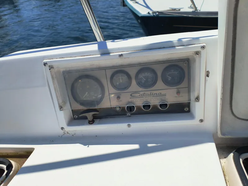 Slide: The Image of Control panel of a 1985 Catalina 27 yacht with gauges and switches. - 14