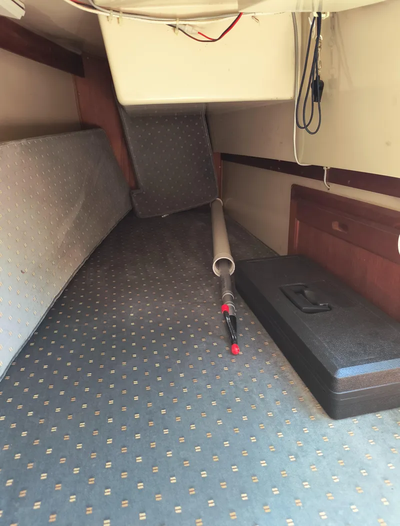 Slide: The Image of Interior cabin of a 1985 Catalina 27 sailboat with cushions and storage. - 26