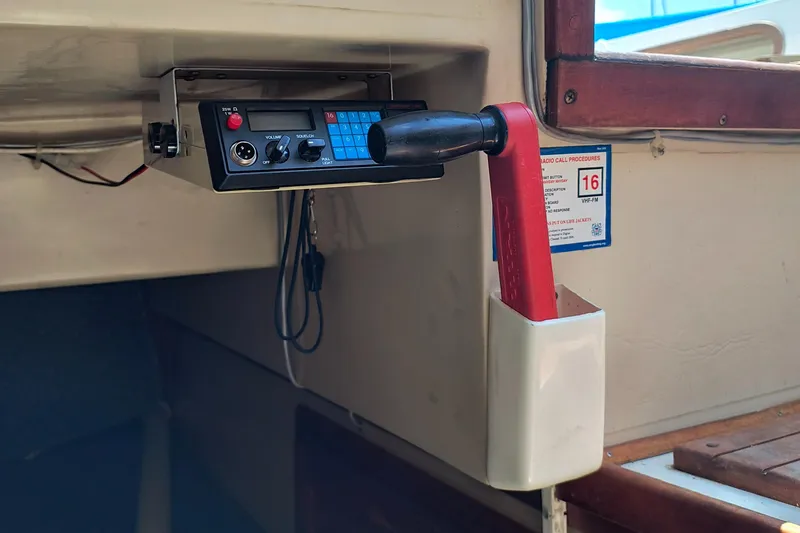 Slide: The Image of Interior of a 1985 Catalina 27 sailboat with radio equipment and throttle lever. - 28