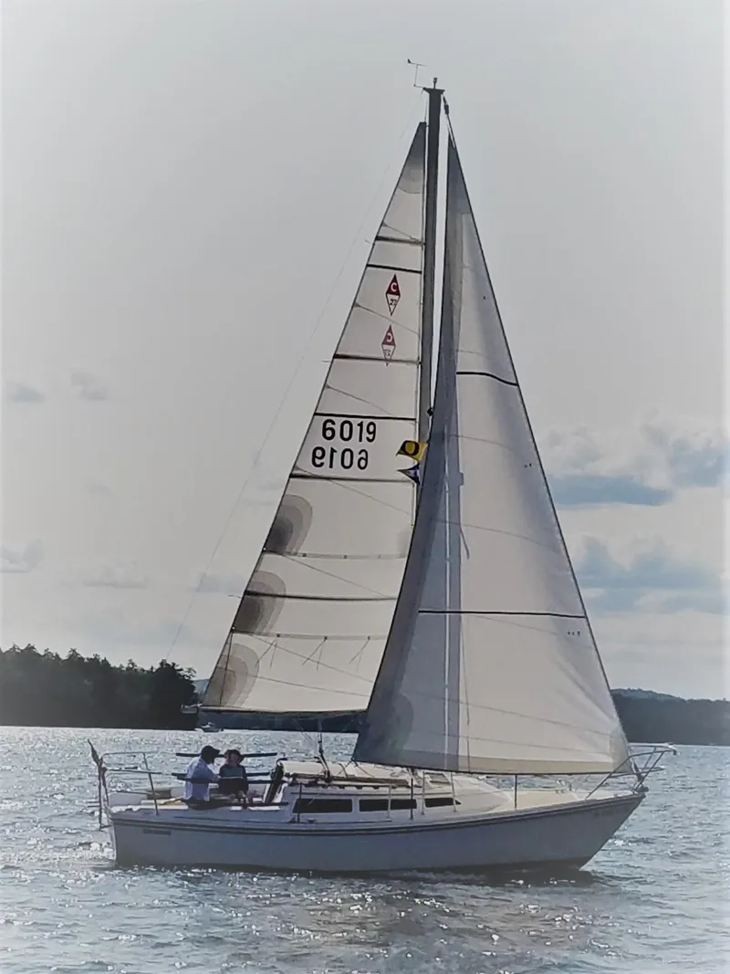 Slide: The Image of 1985 Catalina 27 sailboat on calm waters under a clear sky. - 32