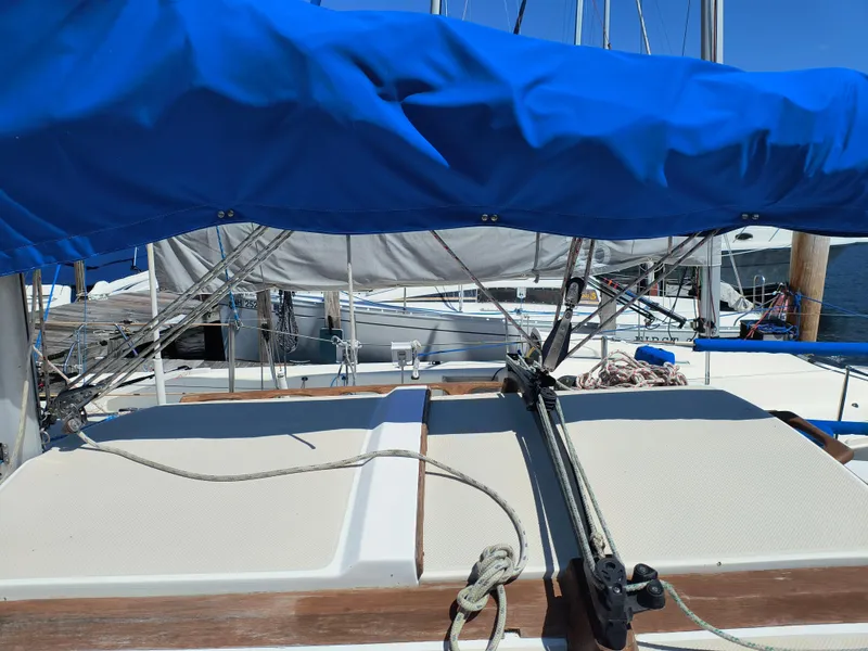 Slide: The Image of 1985 Catalina 27 sailboat deck with blue cover and rigging. - 4