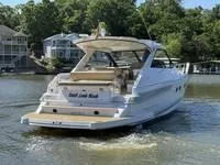 Slide: The Image of 2010 Regal 46 Sport Coupe helm with navigation controls and beige seating. - 11