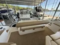 Slide: The Image of 2010 Regal 46 Sport Coupe yacht interior with helm, under covered dock. - 20