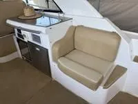 Slide: The Image of Bathroom vanity in 2010 Regal 46 Sport Coupe yacht, featuring a sink and mirror. - 21