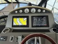 Slide: The Image of 2010 Regal 46 Sport Coupe interior with wood cabinetry and granite countertop. - 26