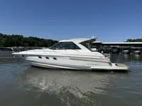 Slide: The Image of 2010 Regal 46 Sport Coupe yacht on calm water, clear sky background. - 4
