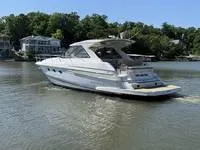 Slide: The Image of Interior of 2010 Regal 46 Sport Coupe with beige seating and kitchenette. - 7