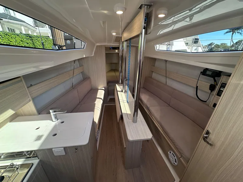 Slide: The Image of Interior of 2025 Maxus 26 yacht, featuring modern seating and compact kitchen area. - 15
