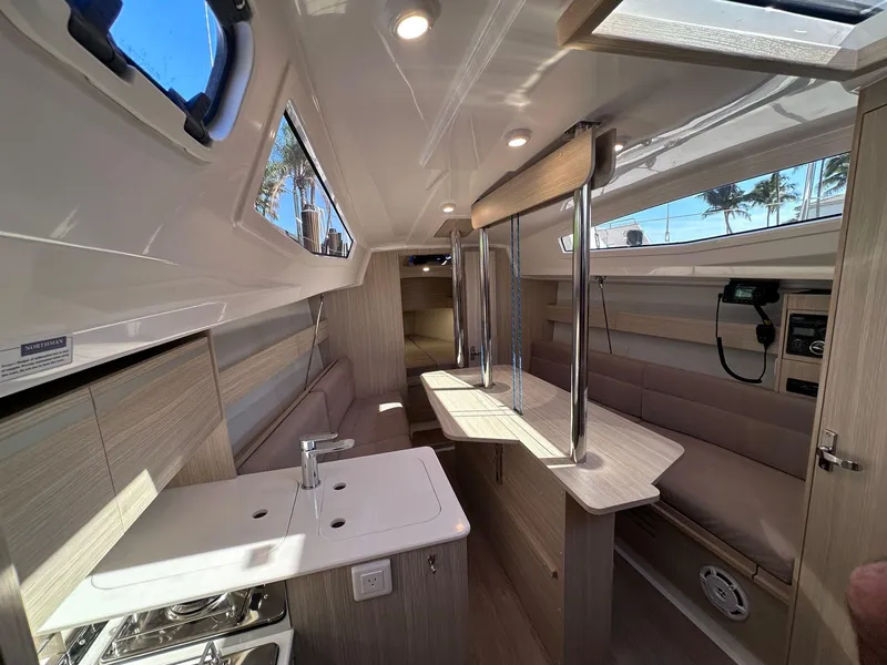 Slide: The Image of Interior of 2025 Maxus 26 yacht, featuring modern design, compact kitchen, and seating area. - 17