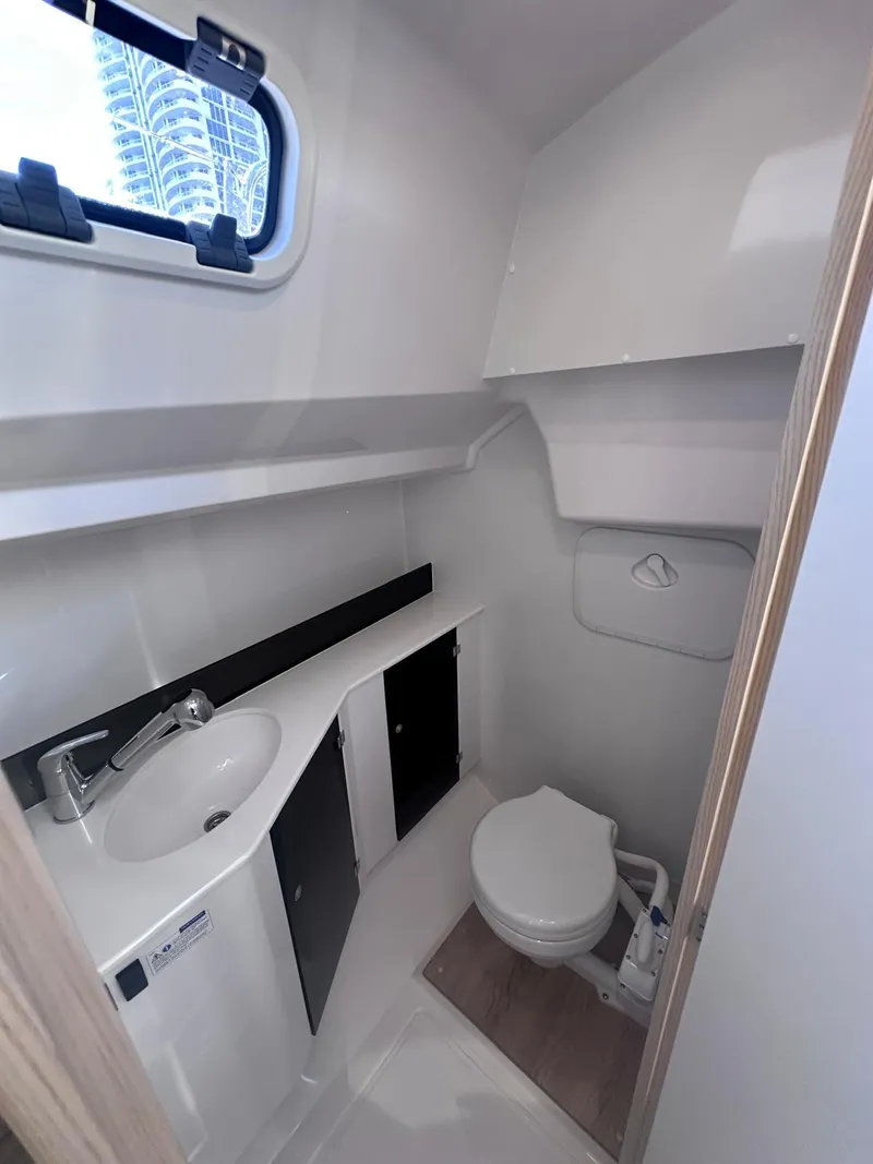 Slide: The Image of Compact bathroom in 2025 Maxus 26 boat with sink, toilet, and window. - 19