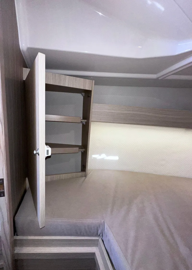 Slide: The Image of 2025 Maxus 26 interior with open cabinet and cozy sleeping area. - 21