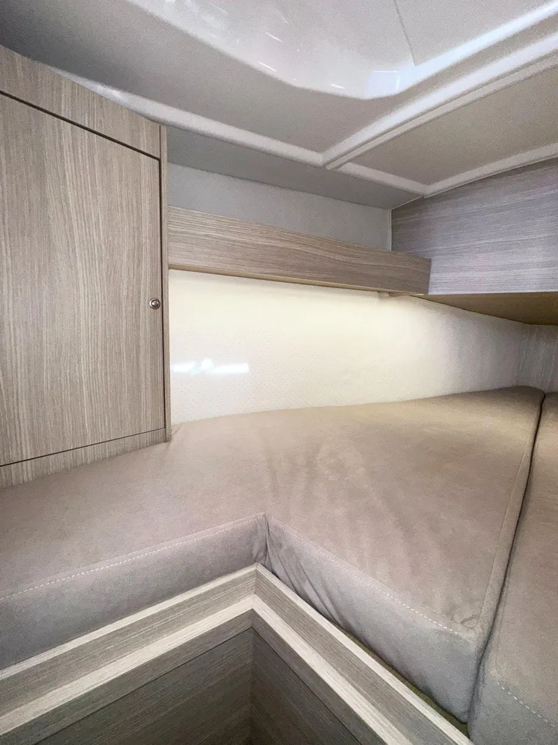 Slide: The Image of 2025 Maxus 26 interior cabin with modern wood finish and cozy sleeping area. - 22
