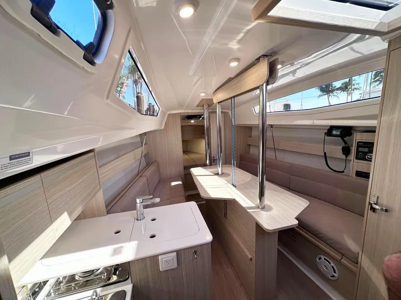 Slide: The Image of Interior of 2025 Maxus 26 yacht, featuring modern kitchen and seating area. - 23