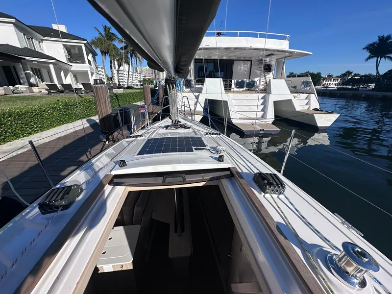 Slide: The Image of Sailboat docked in marina, Maxus 26 model, 2025, sunny day, waterfront homes. - 3