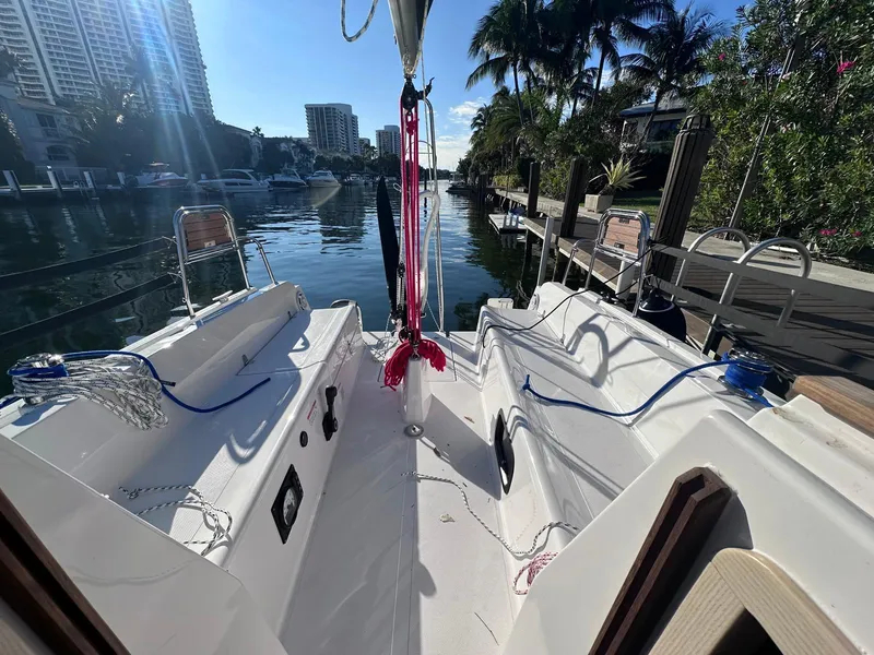 Slide: The Image of 2025 Maxus 26 sailboat docked in a sunny marina with palm trees. - 4