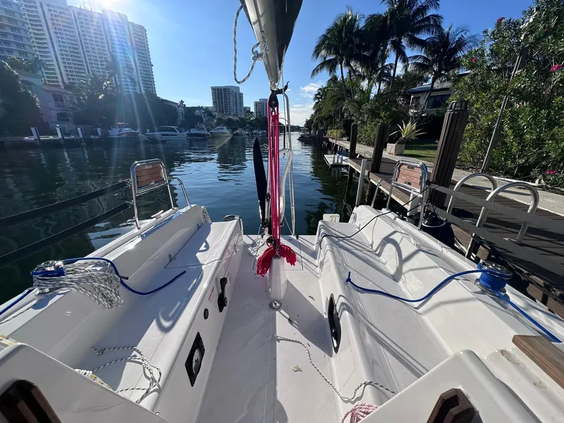 Slide: The Image of 2025 Maxus 26 sailboat docked in a sunny marina with palm trees. - 6