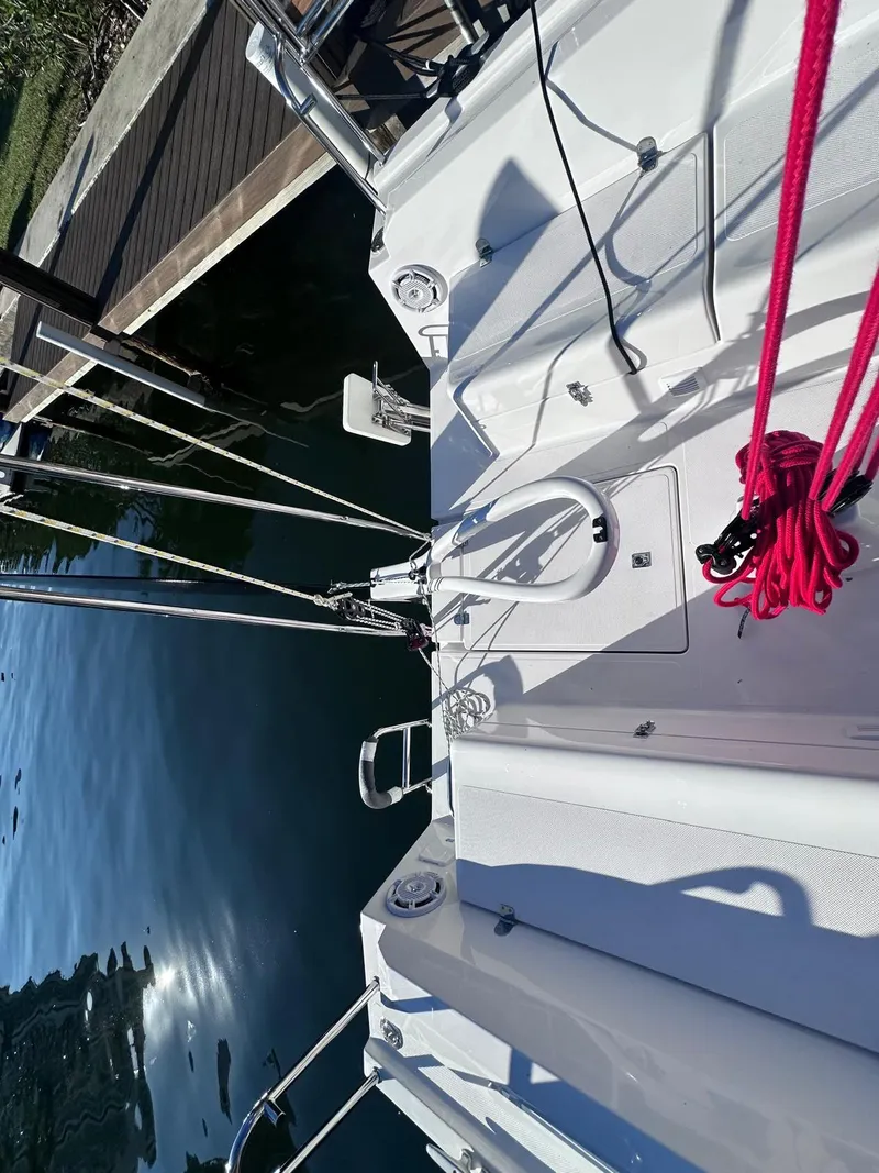 Slide: The Image of 2025 Maxus 26 sailboat docked, featuring sleek deck design and vibrant red ropes. - 9